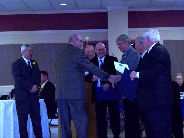 Board Member Buddy Adams receiving his length of service award from the County Commissioners and Delegate Wood